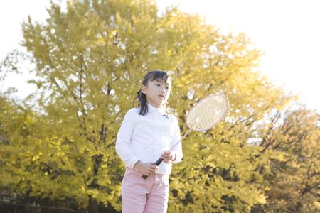 Japanese girl playing badmintonの写真素材