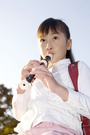 Japanese girl playing the recorderの写真素材