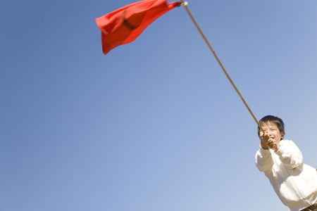 Japanese boy waving a flagの写真素材