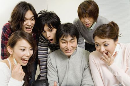 Japanese office workers having brief meetingの写真素材