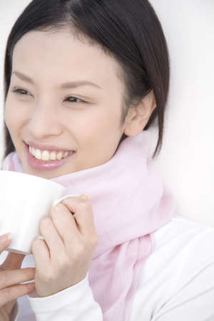 Woman gripping a coffee cupの写真素材
