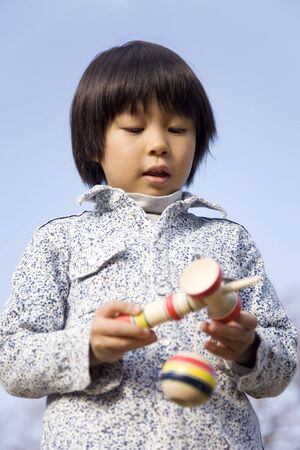Japanese boy playing with cup and ballの写真素材