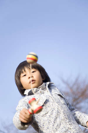Japanese boy playing with cup and ballの写真素材