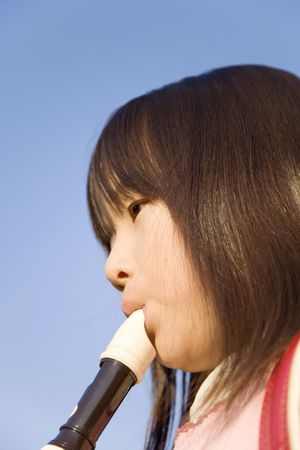 Japanese girl playing the recorderの写真素材