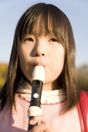 Japanese girl playing the recorderの写真素材