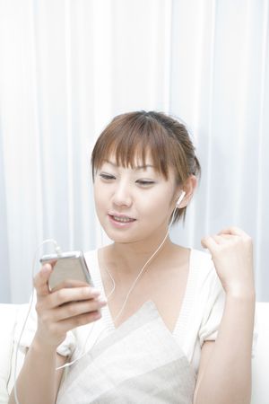 Japanese woman enjoy listening to the musicの写真素材