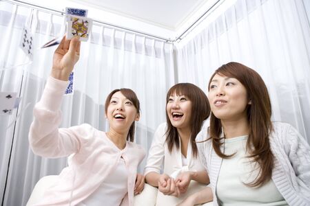 Japanese woman playinng card gameの写真素材