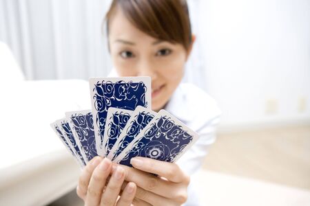 Japanese woman playinng card gameの写真素材