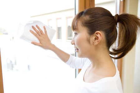 Japanese woman wiping window
