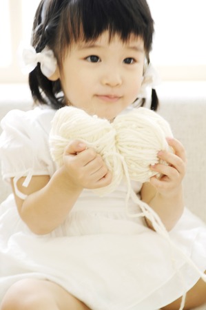 Girl having woolen yarnの写真素材