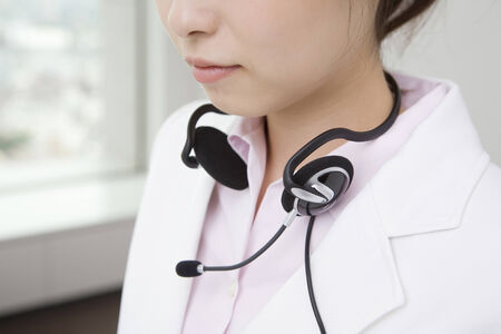 Woman putting on a headsetの写真素材