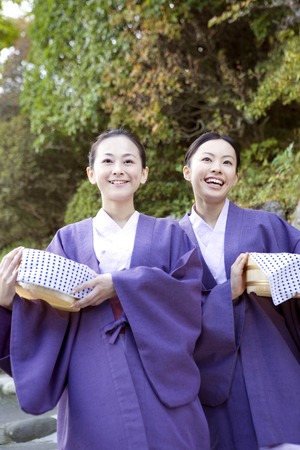Two yukata woman walking with a tubの写真素材