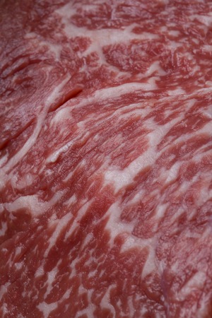 Close-up shot of a  slice of sirloin steak on a lettuceの写真素材