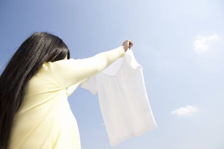 Woman hang out the laundryの写真素材