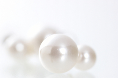 The accessary made with some pearls on the white floor.の写真素材