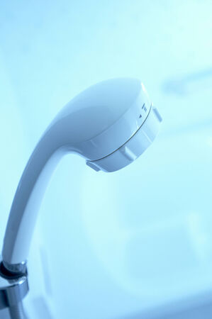 The white shower head which sticks to a wall.の写真素材