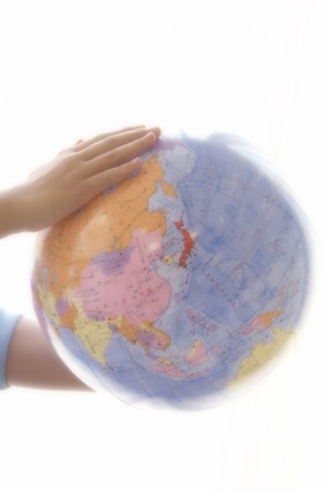 The hands which grasps a vinyl globe.の写真素材