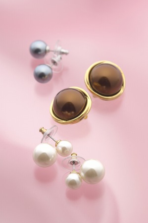 Three kinds of accessaries on the pink table.の写真素材