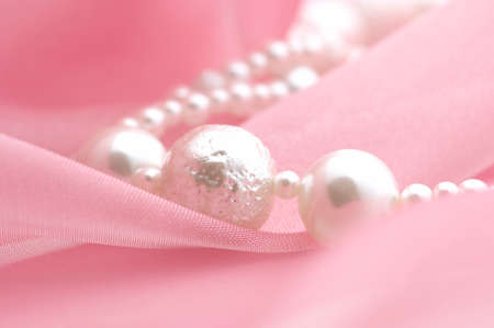 The accessory of silver and pearl on the pink cloth.の写真素材