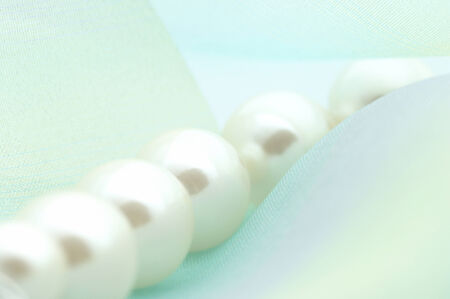 The accessory of pearls on the blue cloth.の写真素材