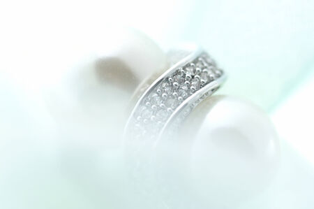 The accessory made by silver and peals on the white cloth.の写真素材