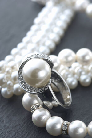 The accessory made by silver and peals on the table.の写真素材