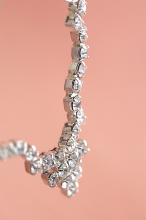 The accessory made by silver on the pink fabric.の写真素材