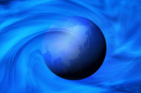 A globe and blue spiral image.の写真素材