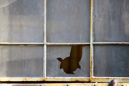 A glass window in a building is broken.の写真素材