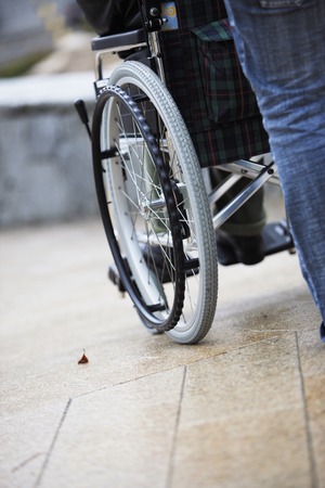 The person who pushes a wheelchair.の写真素材