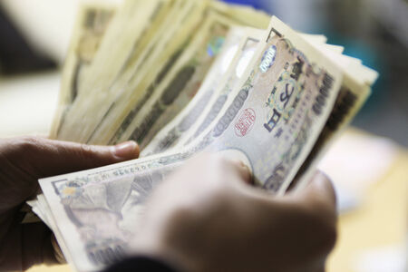 Hands of the person who counts money.の写真素材