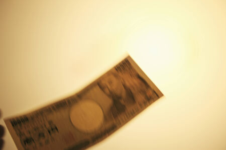 A paper money and beige background.の写真素材