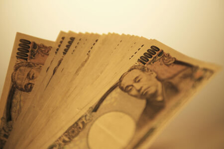A lot of paper money and beige background.の写真素材