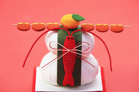 The round rice cake offered to gods at New Year's displayed at New Year's and red background.の写真素材