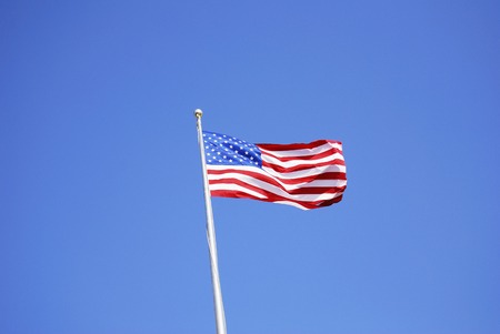 Flag of the Star-Spangled Banner and sunny blue sky.の写真素材