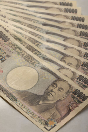 A lot of Japanese paper money on the table.
