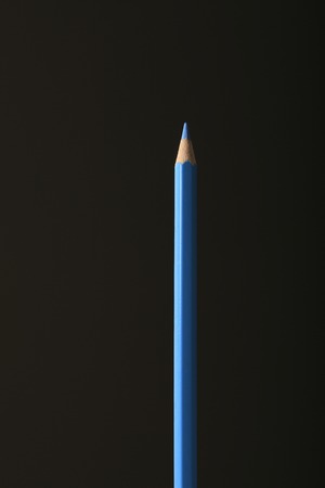 A blue colored pencil and black background.の写真素材