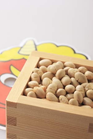 A lot of beans in the box and Demon's face.の写真素材