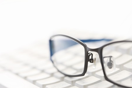 Eyeglasses and keyboardの写真素材