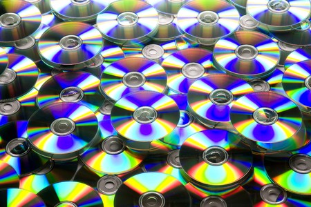 Pile of many CDs or DVDs background