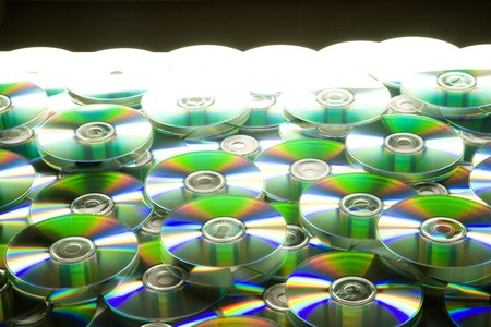 Pile of many CDs or DVDs backgroundの写真素材