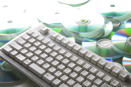 keyboard on pile of many CDs or DVDsの写真素材