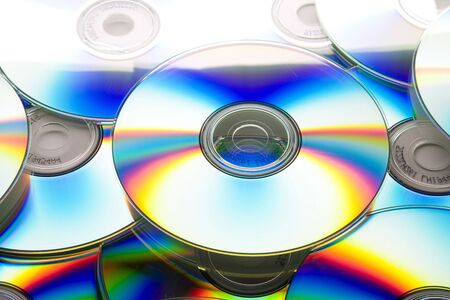 Pile of many CDs or DVDs backgroundの写真素材