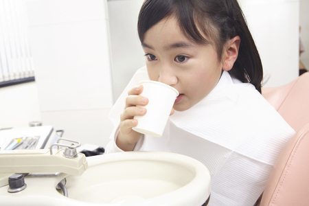 Children to gargle after dental treatmentの写真素材