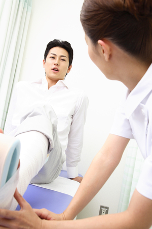 Nurse patient's foot wound bandagesの写真素材