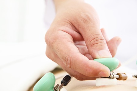 Hand of the doctor to attach the sucker of the electrocardiogram to patient