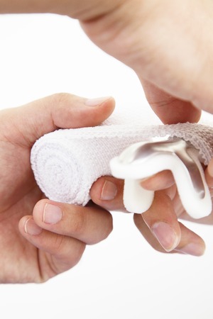 Hand of the doctor to fix the fracture of finger splint and bandage