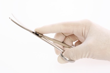 Hand of a doctor with scissorsの写真素材