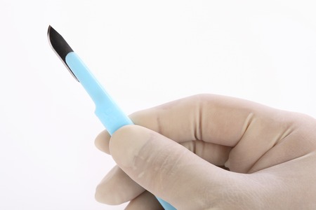 Hand of a doctor with a knifeの写真素材