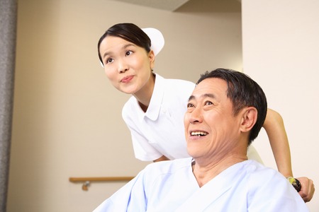 Nurse pushing a patient riding in a wheelchair